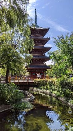 the pagoda is surrounded by trees and water