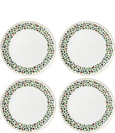 four white plates with green and red designs