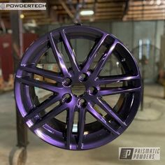 a purple wheel hanging from a metal pole