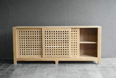 the sideboard is made out of wood and has perfored panels on it