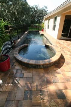 a small pool in the middle of a brick patio