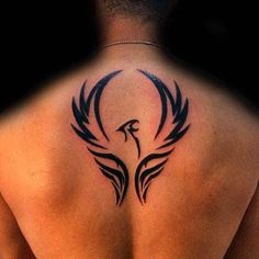 the back of a man with a tattoo on his upper and lower back, in black ink