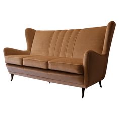 a brown couch sitting on top of a white floor