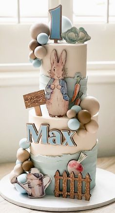 a three tiered cake with an image of a rabbit on it