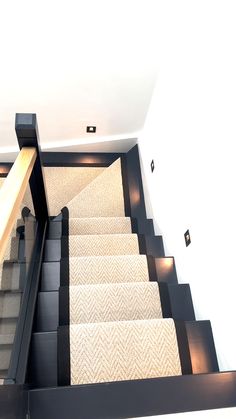 a staircase with carpeted steps leading up to the second floor