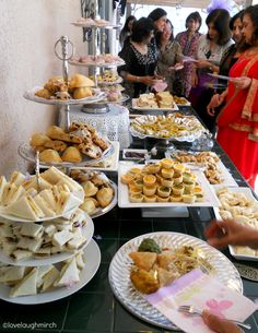 people standing around a buffet table filled with food