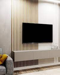 a large flat screen tv mounted to the side of a wall in a living room