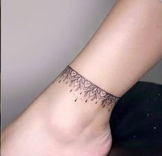 a woman's foot with a small tattoo on the side of her leg,