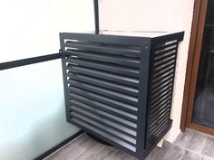 a black radiator sitting on the side of a building