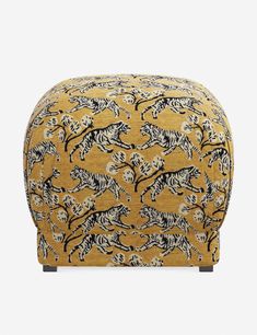 a yellow ottoman with black and white zebras on it's legs, sitting in front of a gray background