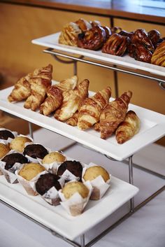 three trays with pastries on them sitting on a table