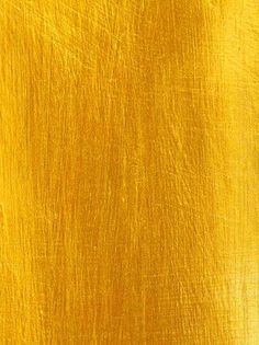 an image of a yellow background that looks like it has been painted with gold paint