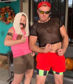 a man and woman dressed in costumes standing next to each other on the front porch