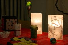 some paper bags sitting on top of a table with lights and decorations in the background