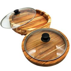 two round wooden containers with lids on each one and a glass lid on the other