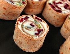 there are several wraps with different toppings on the top one is filled with cream cheese and cranberries