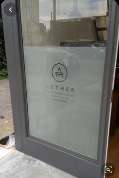 an open door with the word aether written on it in front of a building