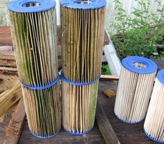 four different types of air filters sitting next to each other on top of wood planks