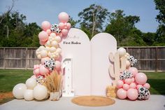 an outdoor area with balloons and decorations