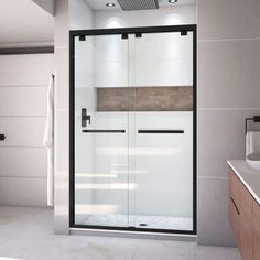 a bathroom with a walk in shower next to a sink