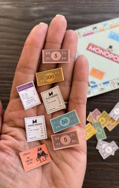 a person holds out their monopoly game pieces