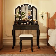 a bedroom with a vanity, mirror and stool