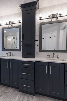 a bathroom with double sinks and two mirrors