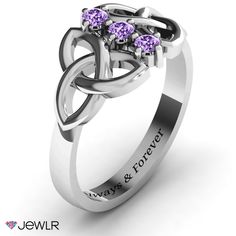 a white gold ring with three purple sapphires on the center and an inscription that says love