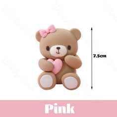 a brown teddy bear with a pink heart on it's chest sitting in front of a white background