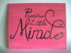 a pink sign with black writing on it that says, precious and little miracles