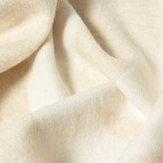 a close up view of a white fabric textured with wool and cotton blends