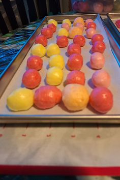 there are many different colored candies on the tray