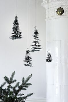 three black and white trees hanging from the ceiling