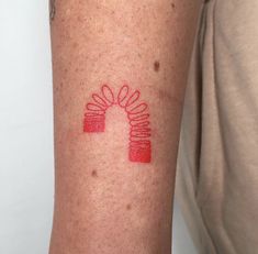 a person with a red tattoo on their arm