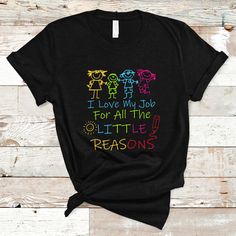 i love my job for all the little reasons t - shirt on a wooden background