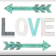 the word love written in wood letters with arrows