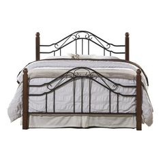 a bed with metal headboard and foot board on top of white bedspread