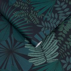 a green and black wallpaper with large leaves on it's back ground,