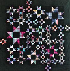 a black quilt with colorful stars on it