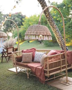 an outdoor daybed with pillows and lamps on it