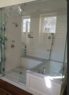 a bathroom with a walk in shower next to a bath tub