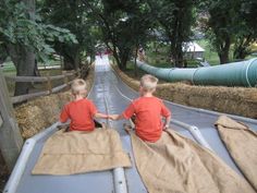 two young boys sitting on the back of a truck