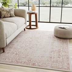 a living room with a couch, chair and rug