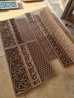 four different types of decorative metal grates laid out on the ground