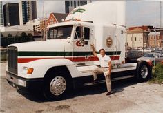 a man standing next to a large semi truck