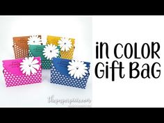 colorful gift bags with white flowers on them