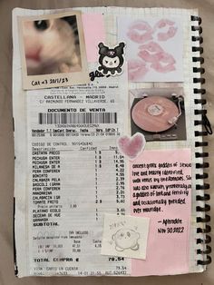 an open notebook with pictures and words on it, including a cat's face