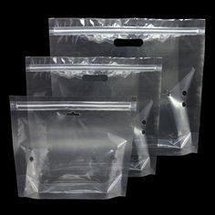 three clear plastic bags on a black background