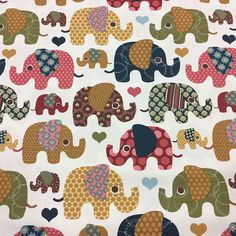 an elephant print fabric with hearts on it's back and two elephants in the background