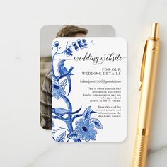 a blue and white wedding card with a gold pen next to it